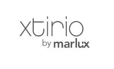 Logo mit stilisierter Aufschrift "xtirio by marlux" auf weißem Hintergrund. Die Buchstaben sind in einer schlanken, modernen Schriftart gehalten.