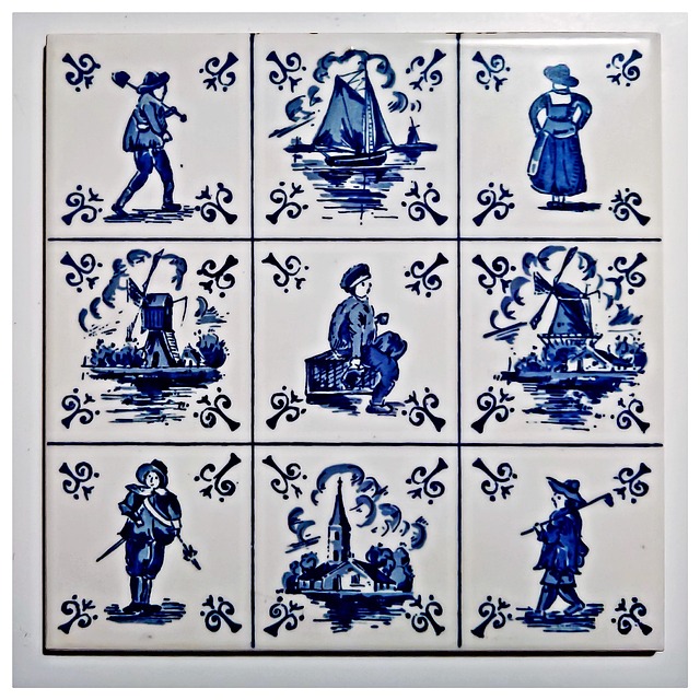 Neun quadratische, weiß-blaue Fliesen mit traditionellen holländischen Motiven wie Windmühlen, Segelbooten, Bauern und einer Kirche, jeweils eingerahmt von floralen Ornamenten.