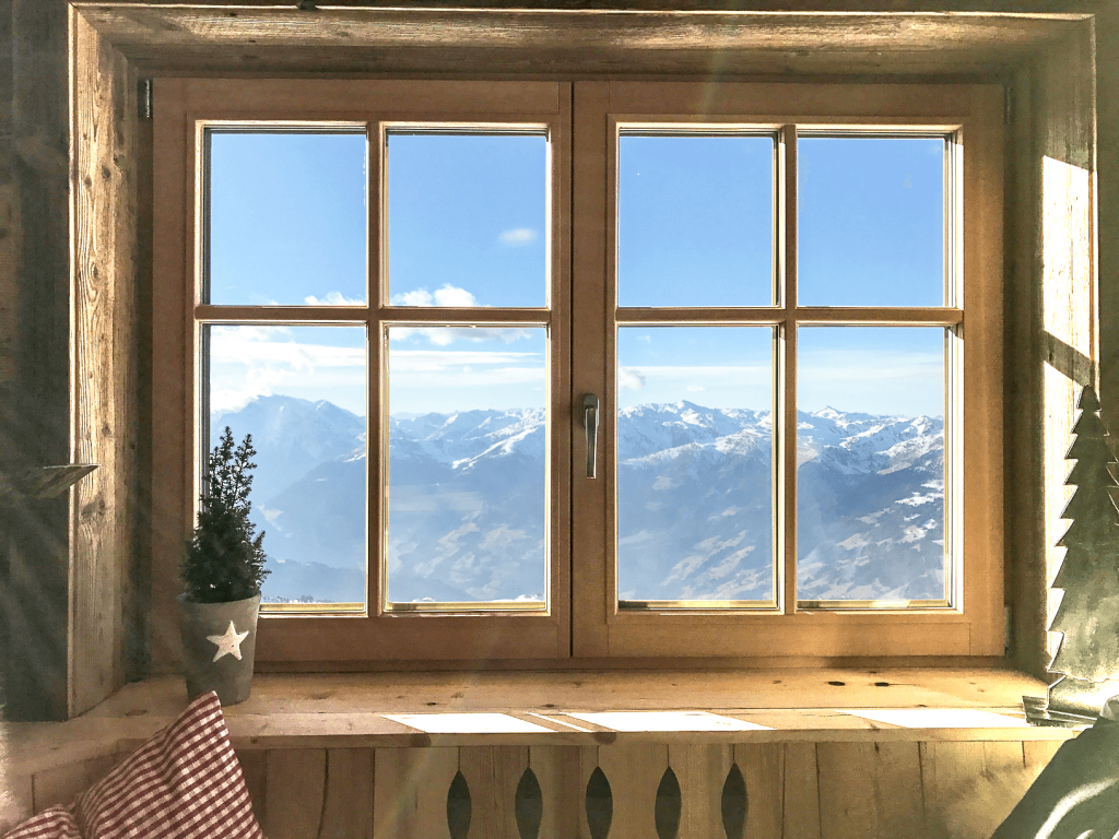 Holzfenster mit Blick auf Alpen