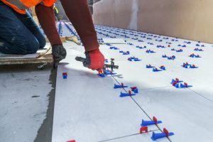 Fliesenleger installiert ein Nivelliersystem