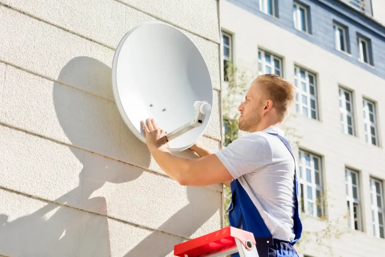 Elektriker bei der Montage einer Satellitenschüssel