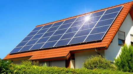Photovoltaikanalge auf einem Dach von einem Einfamilienhaus mit blauem Himmel im Hintergrund
