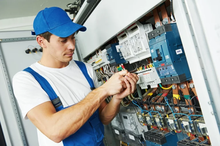 Elektriker bei der Arbeit an einem Sicherungskasten der zum Berufsrisiko zählt