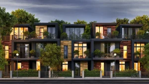 Moderne Reihenhäuser mit großen Glasfenstern und Balkonen, umgeben von Bäumen und Grünflächen. Die moderne Fassadengestaltung kombiniert dunkle Akzente mit Holzverkleidungen und minimalistischen Designelementen. Außenbeleuchtung und Vegetation schaffen eine einladende Atmosphäre in einem urbanen Wohnviertel.