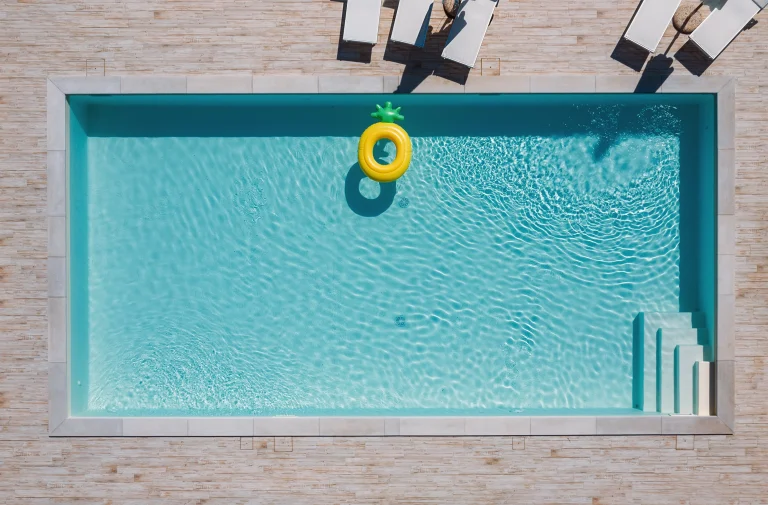 Pool von oben mit einem gelben Schwimmring im Wasser