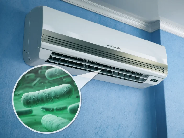 Eine an der Wand montierte Klimaanlage mit grafischer Darstellung von Legionellen-Bakterien, die auf eine mögliche Kontamination des Geräts hinweist.