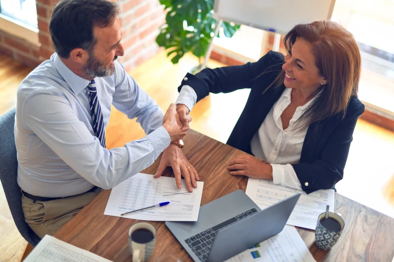 Kollegen schütteln sich die Hände.