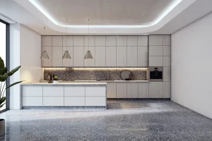 Moderne, minimalistische Küche mit einer Kochinsel und grifflosen Fronten in heller Holzoptik. Der gesamte Raum ist mit einem fugenlosen, grau melierten Terrazzoboden ausgestattet, dessen Muster sich im Fliesenspiegel der Küchenzeile widerspiegelt.